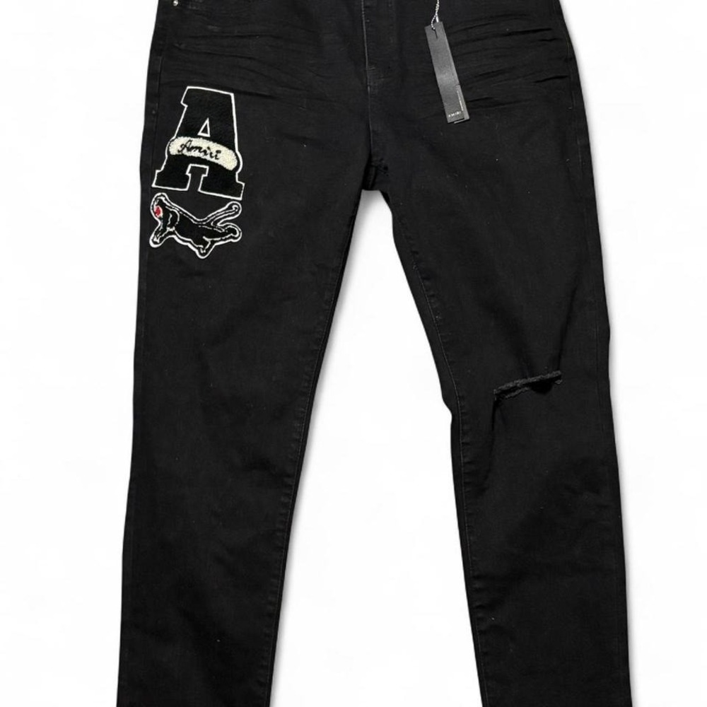 Black Amiri skinny jeans with‎ embroidered logo and distressed details